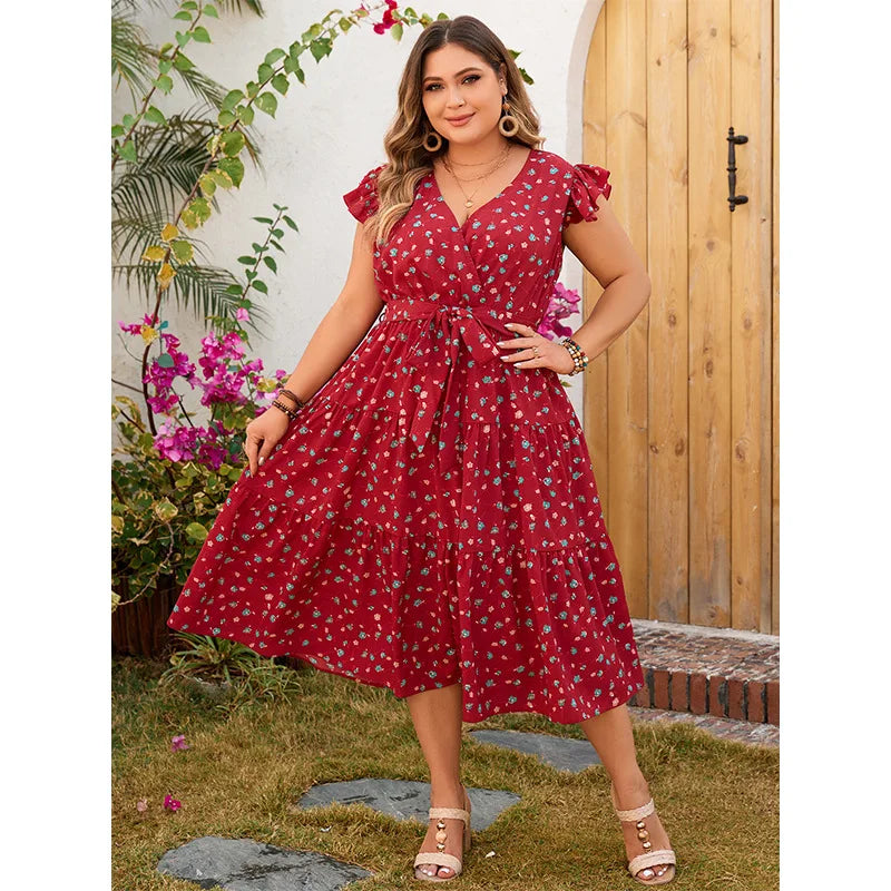 Vestido midi feminino, solto e confortável, com decote em V e sem mangas. Apresenta estampa floral delicada, babados e pregas que adicionam charme e movimento. Ideal para looks casuais de verão