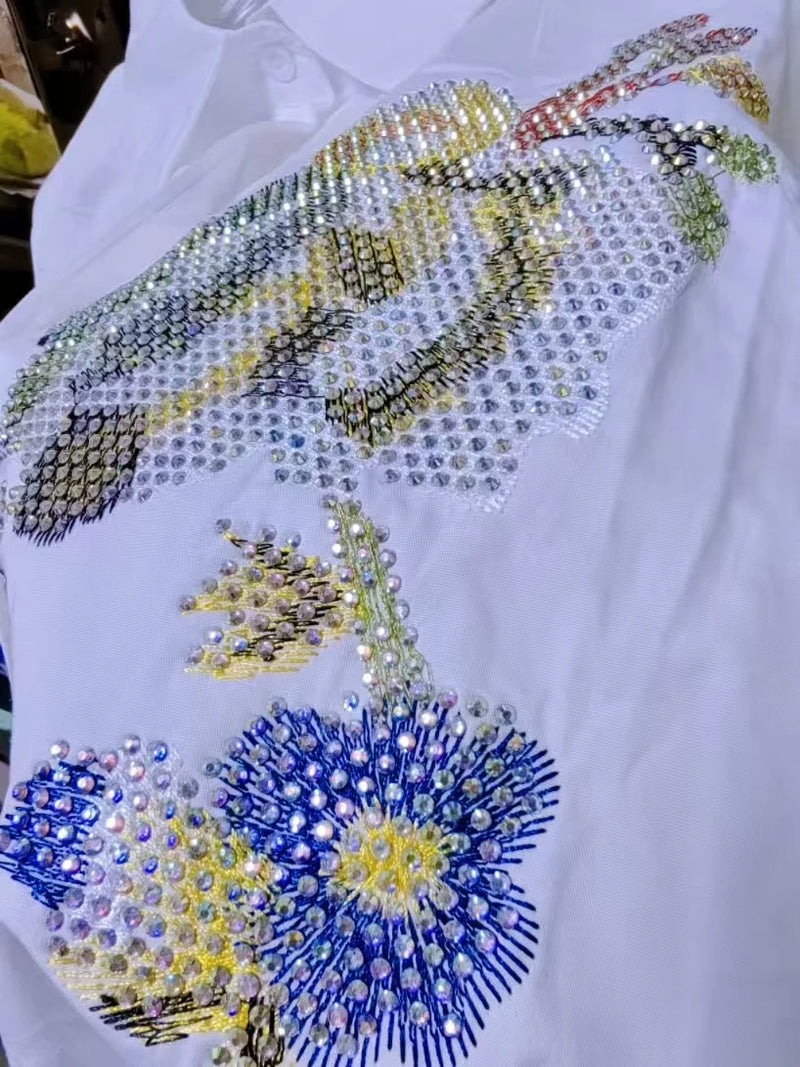 Adicione um toque delicado e elegante ao seu guarda-roupa com esta blusa feminina bordada com flores. Confeccionada em 100% algodão puro, é leve, respirável e confortável, perfeita para o verão.